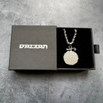 gumgum fruit necklace sitting in a branded jewelry box against a grey background